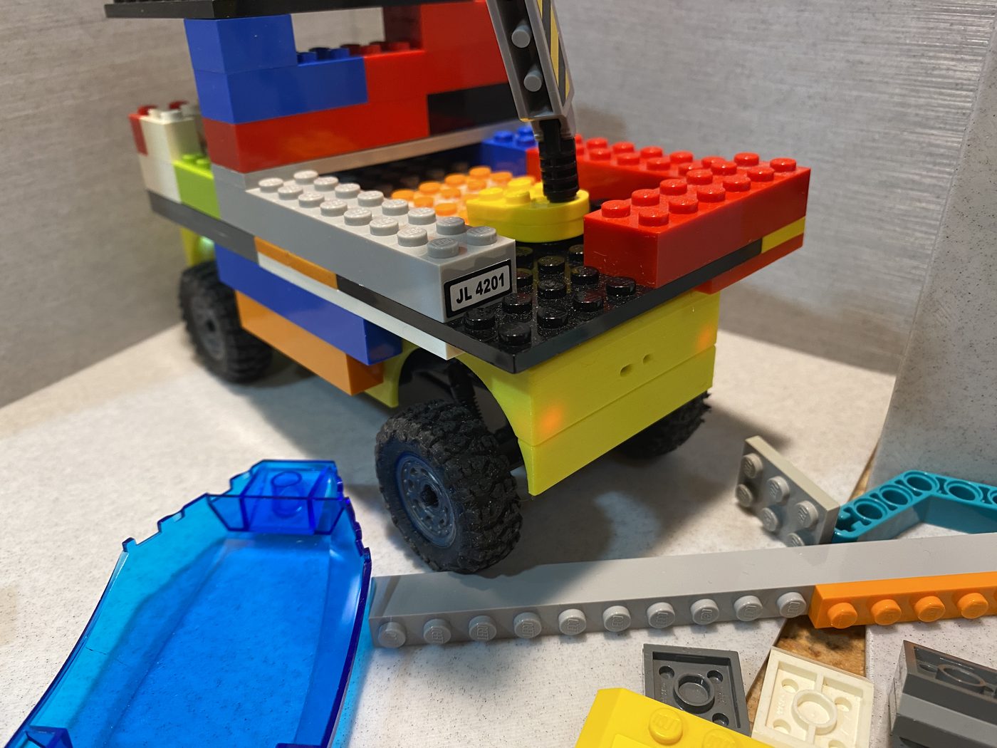 Close view of a base plate glued to the enclosed platform, with bricks built up from it.