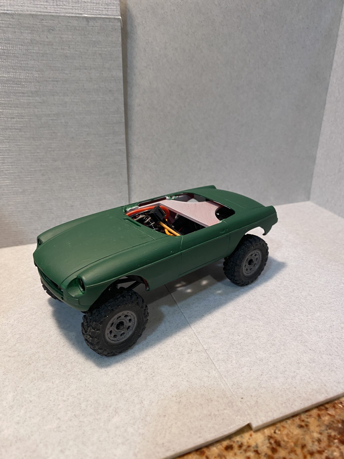A green MGB sports car body mounted on the crawler chassis.