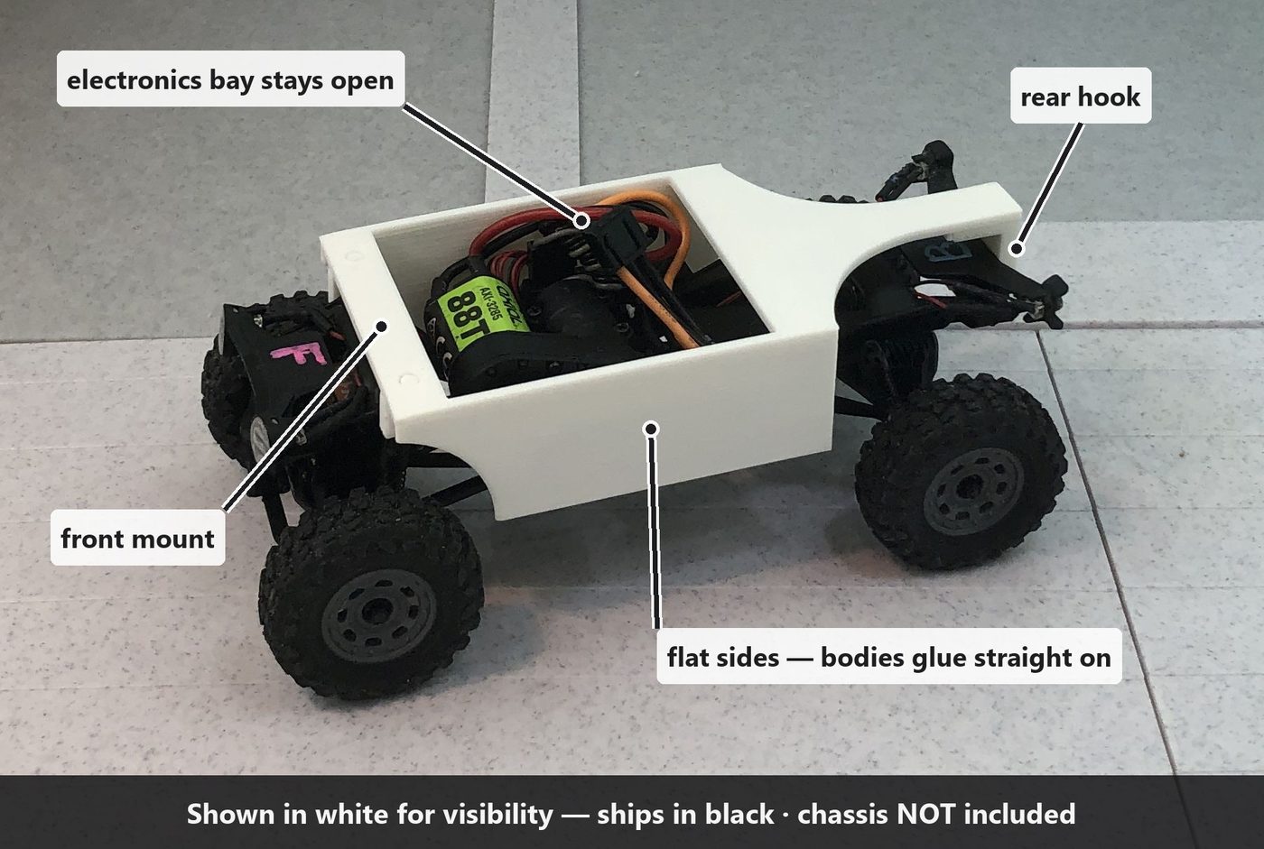 The long shell mounted on the chassis, labelled: front mount, rear hook, open electronics bay, flat glue-ready sides.