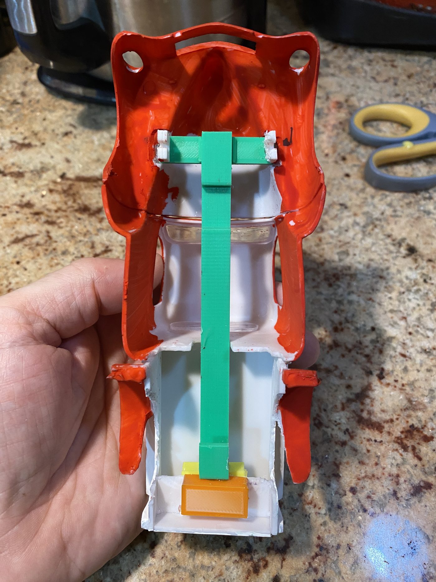 A body turned upside down with the rail, front plank and rear hook glued inside it.